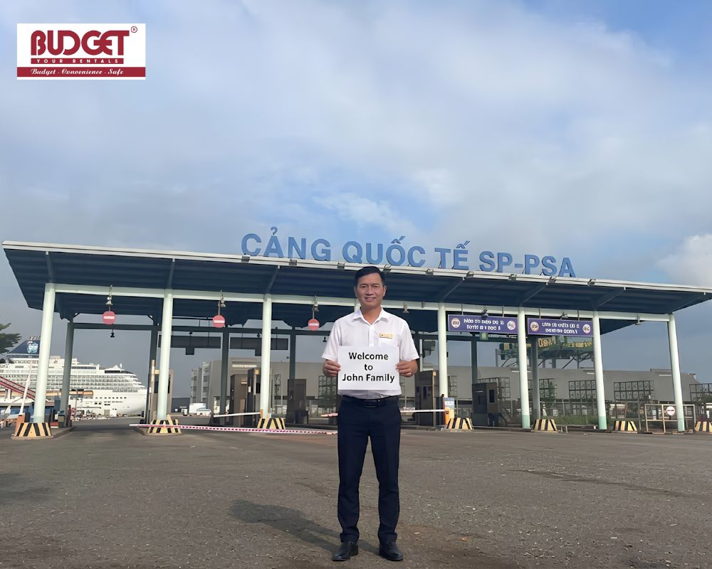Our-driver-stood-in-front-of-Phu-My-port-gate-holding-a-welcome-sign-for-the-John-family