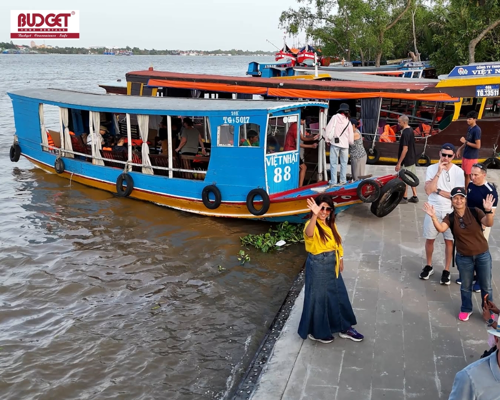 Travelers get ready to board the boat to return to My Tho Pier