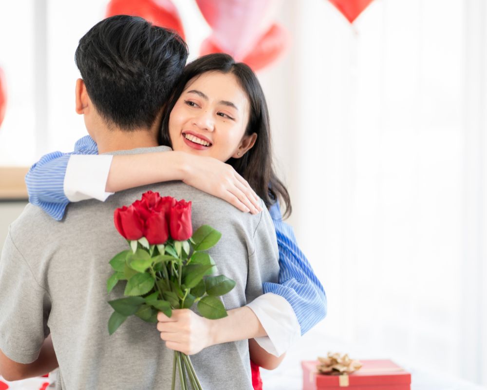 Couple showing love surprise giving flowers