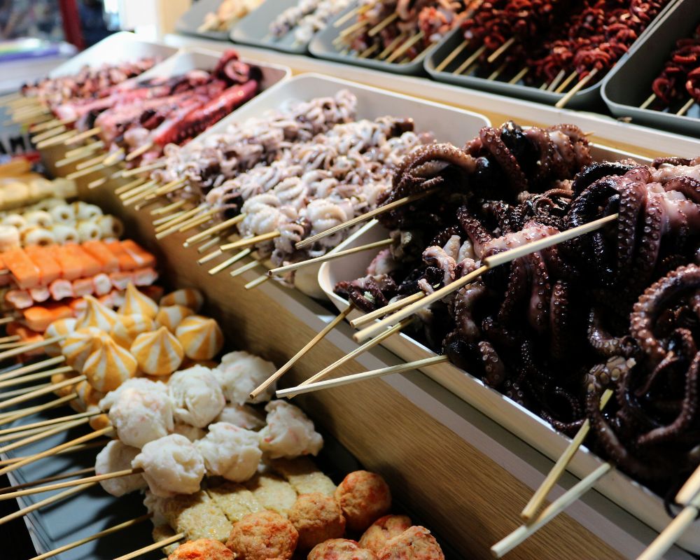 Various seafood satay including octopus and squid satay sell in street food market