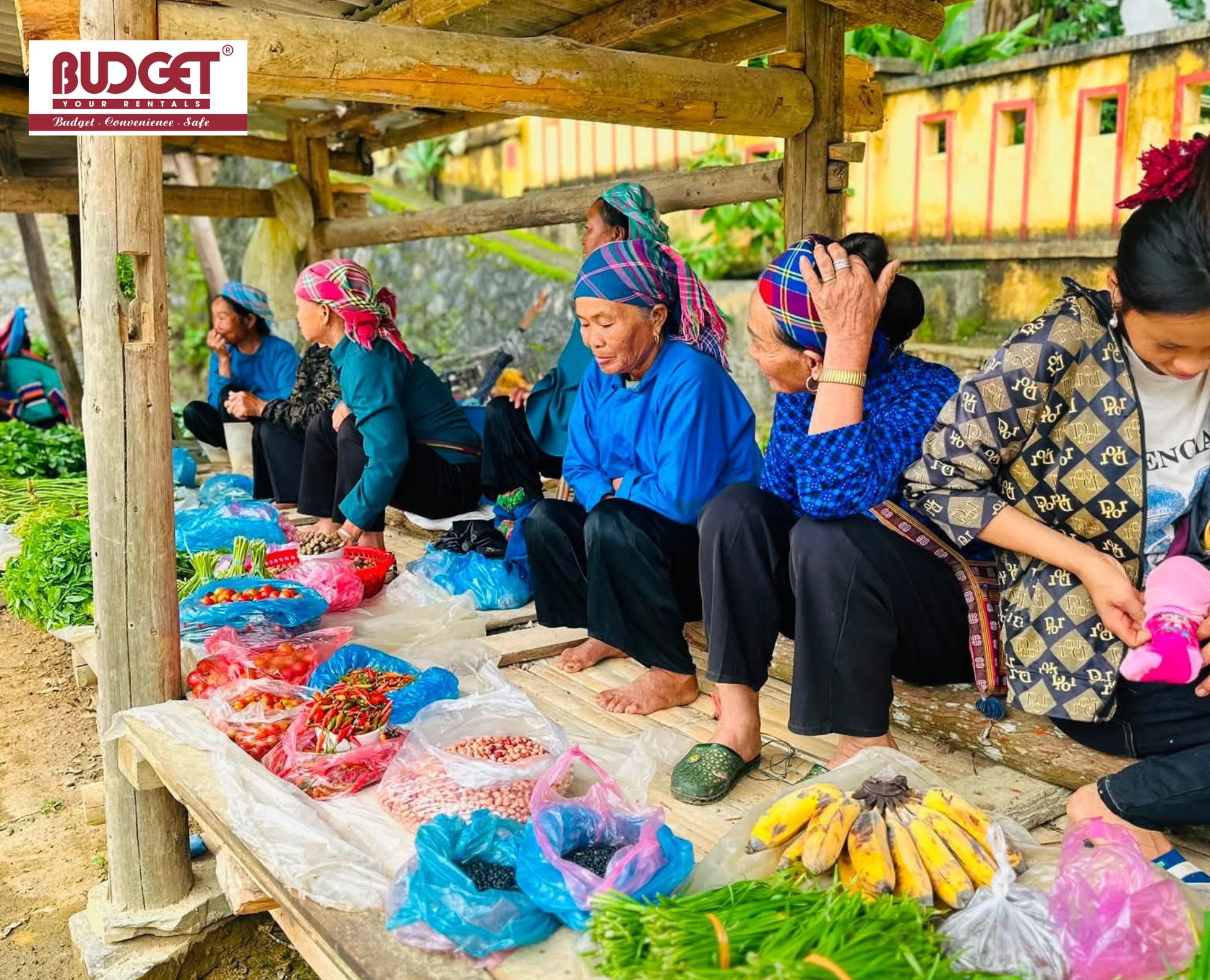 Local-ethnic-women-who-sit-at-a-wooden-stall-displaying-fresh-produce-at-a-traditional-market