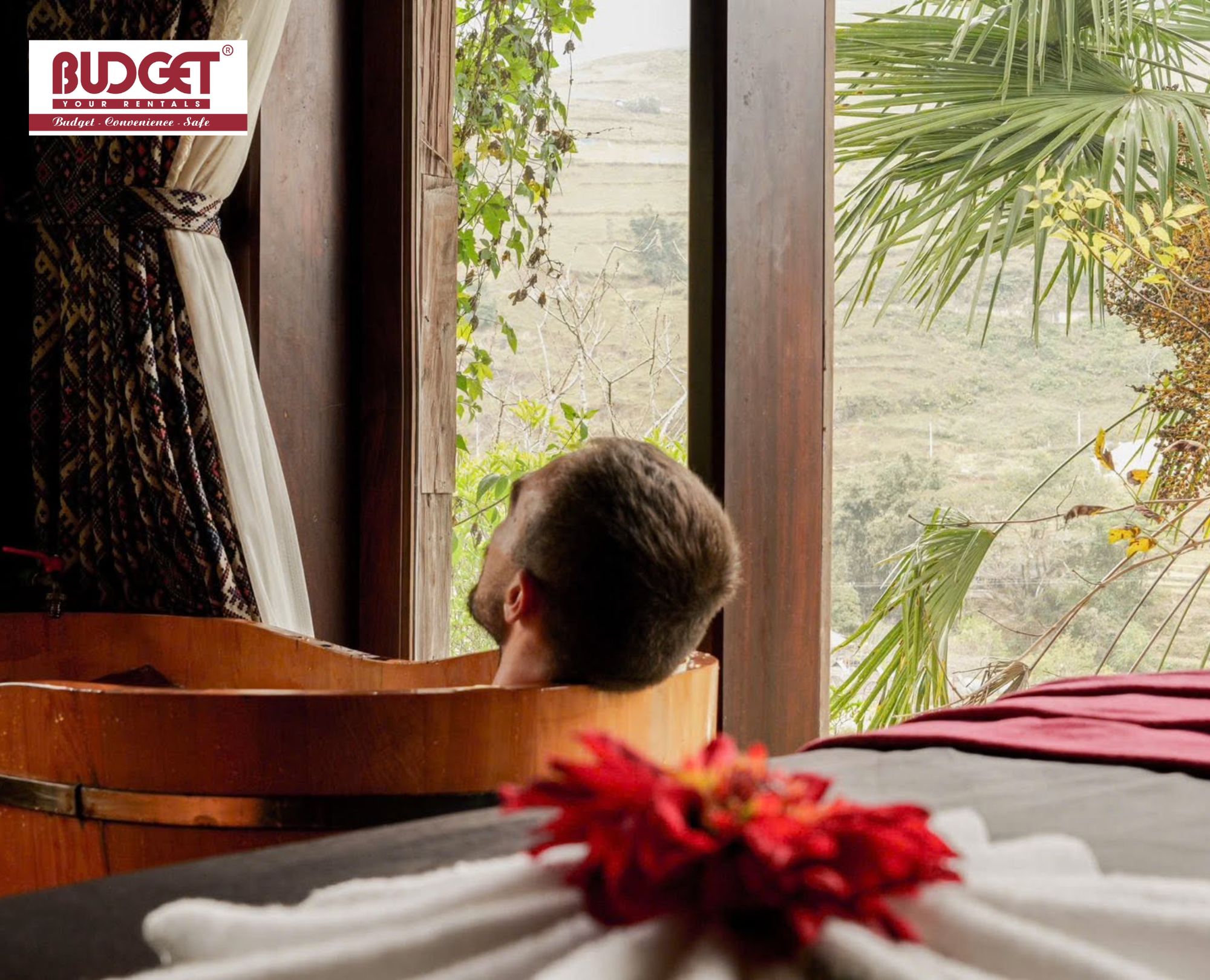 Man-who-relaxes-in-a-traditional-wooden-tub-enjoys-mountain-scenery-during-a-herbal-bath