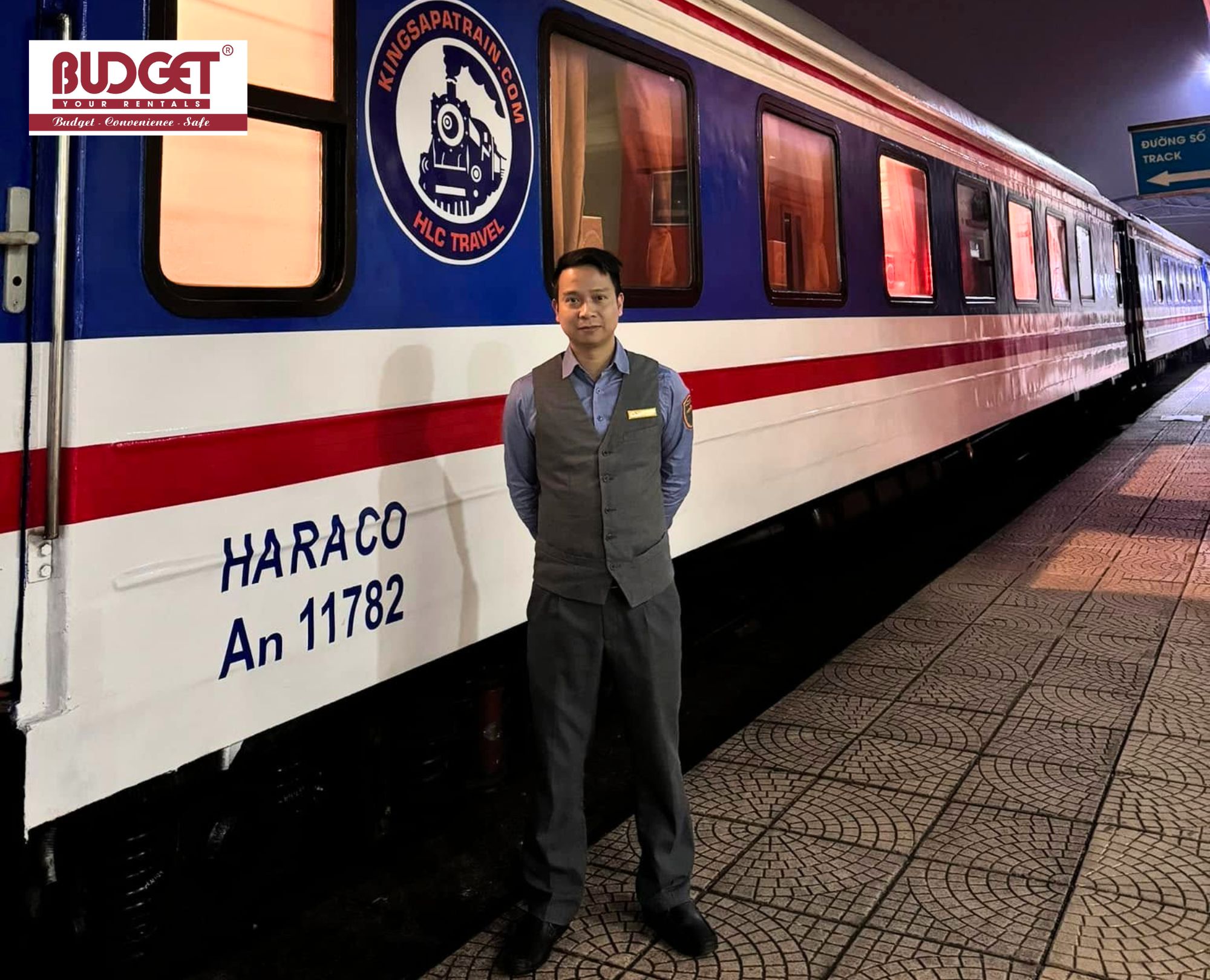Train-attendant-standing-proudly-next-to-a-passenger-carriage-at-the-station-platform
