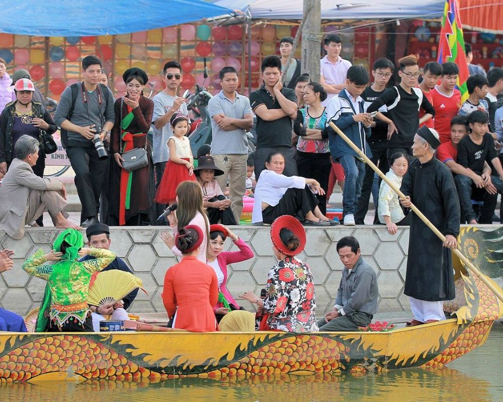 Quan Ho folk singers performing on a dragon boat at Lim Festival in Bac Ninh