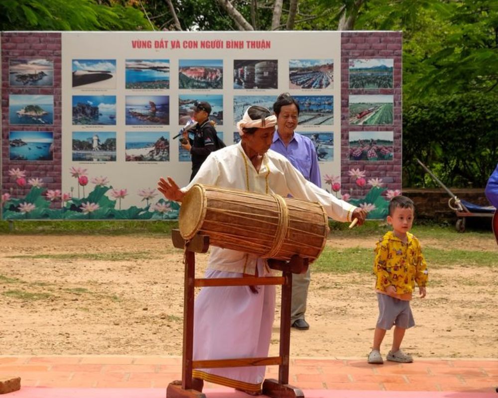 Cham musician playing a traditional drum as part of the Kate festival celebrations