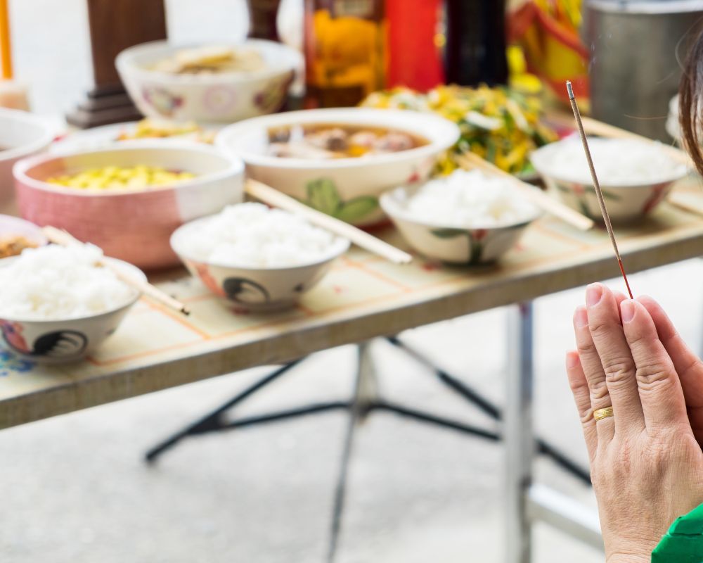 Hand woman clasped holding incense