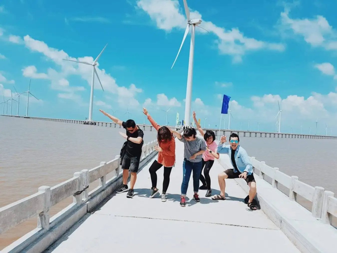 A group of people taking photo at the Wind Farm