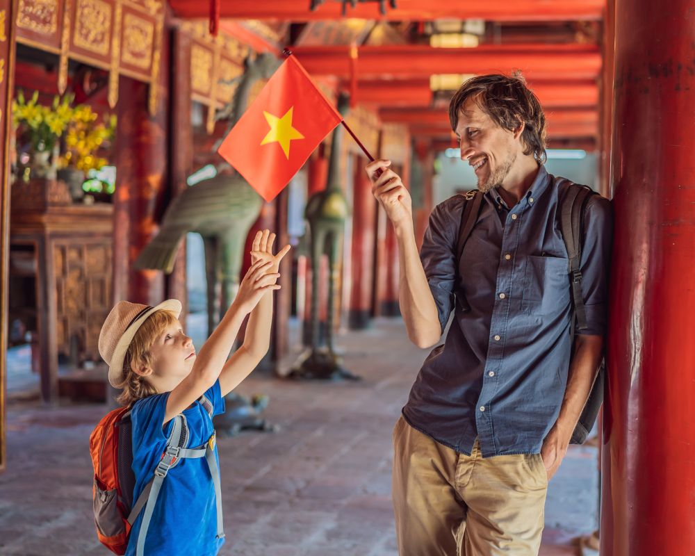 Father and son tourists in Temple of Literature in Hanoi