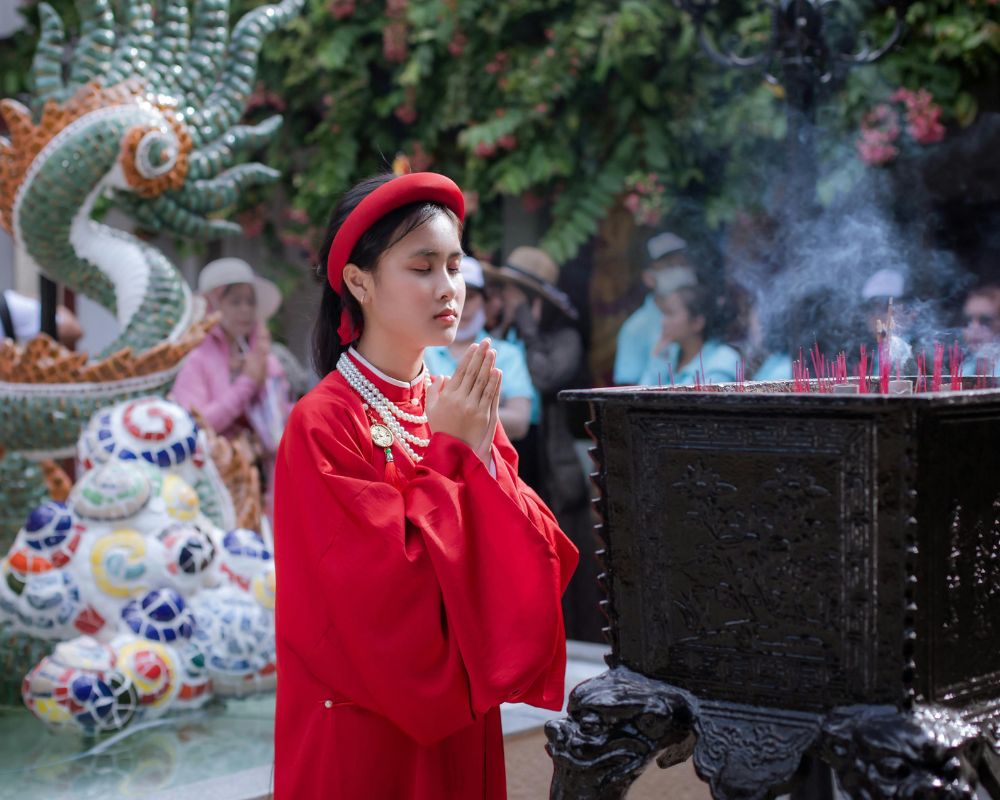 Vietnamese woman praying in temple